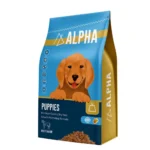Alpha Puppies Dry Dog Food, clearly showing the brand, product name, and a playful, healthy puppy (could be a mixed breed or a common puppy breed) on the packaging.